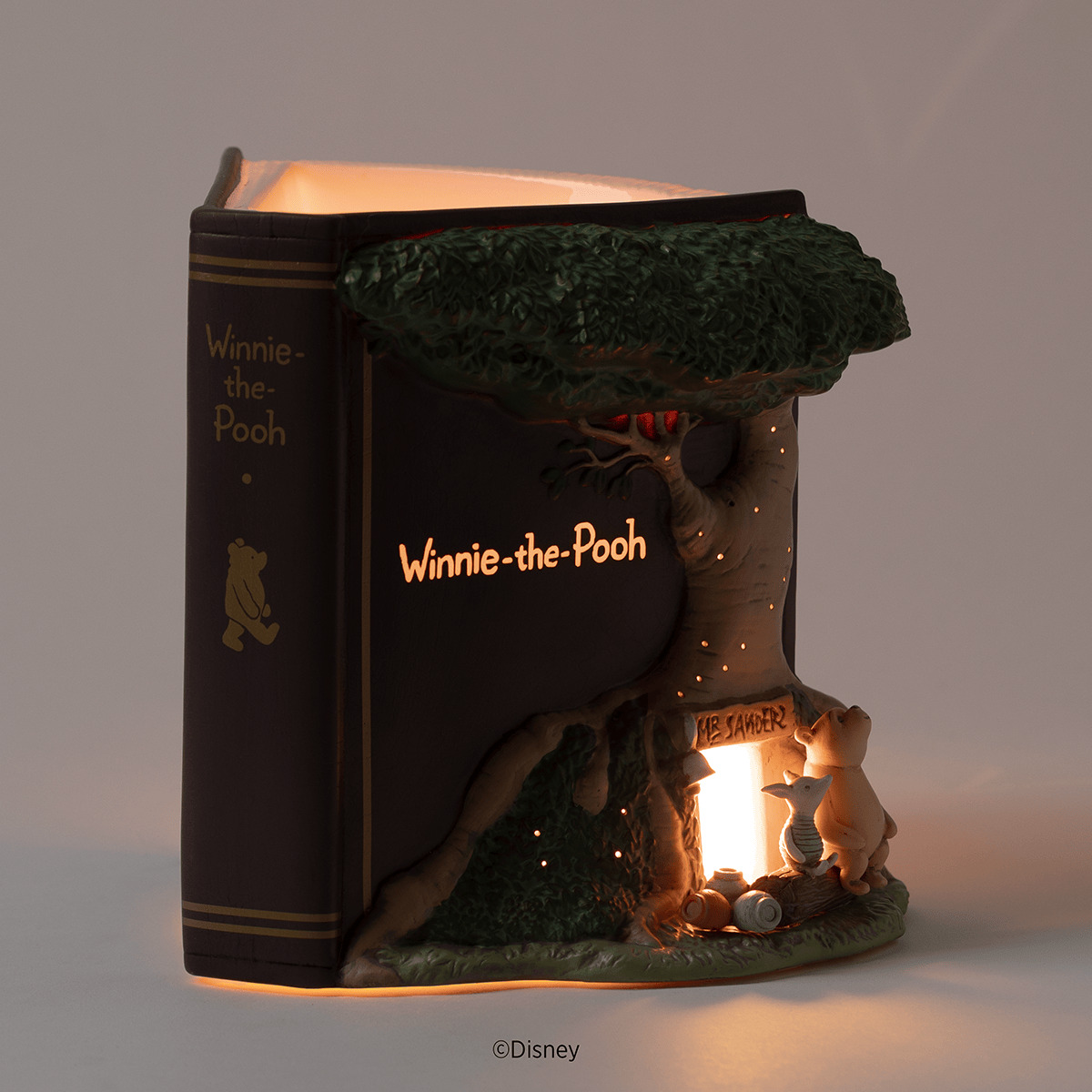 Disney Winnie the Pooh 100 Years of Friendship Scentsy Warmer 2026 Winnie the Pooh 100 Years of Friendship Scentsy Warmer glowing in a dark room